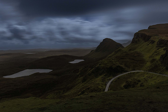 The curves of the Quiraing under a cloudy full moon sky.